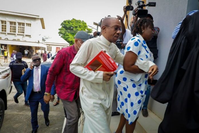 Emefiele clutching a Bible